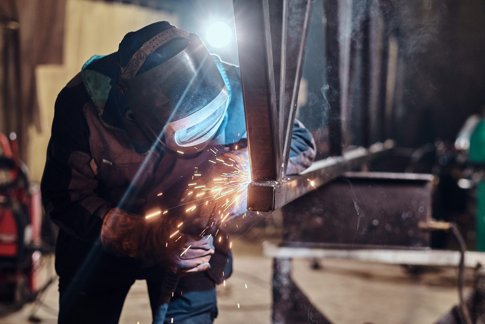 Man is working at the busy metal factory